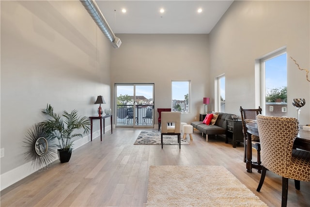 3809 Liberty Ave Unit 403, Lawrenceville, PA 15201 - living room featuring a towering ceiling, light wood finished floors, baseboards, and recessed lighting