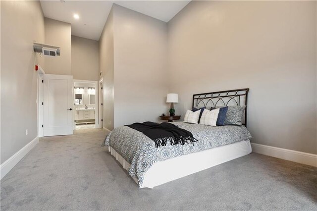 3809 Liberty Ave Unit 403, Lawrenceville, PA 15201 - bedroom featuring a towering ceiling, carpet floors, baseboards, and ensuite bathroom