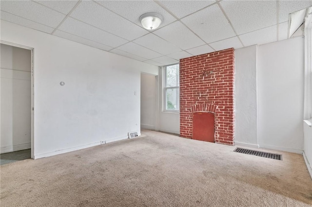 3318 Juliet St, Oakland, PA 15213 - unfurnished living room featuring carpet flooring, a paneled ceiling, a brick fireplace, and baseboards
