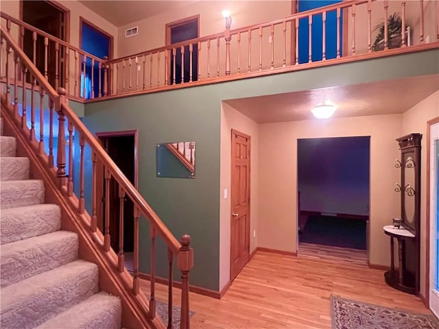 101 Pheasant Run Dr, Worth Twp But, PA 16057 - staircase with wood finished floors, baseboards, and a towering ceiling