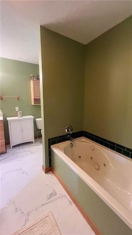 101 Pheasant Run Dr, Worth Twp But, PA 16057 - full bath featuring marble look tile flooring, a jetted tub, toilet, and baseboards