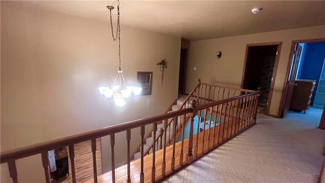 101 Pheasant Run Dr, Worth Twp But, PA 16057 - hallway featuring an upstairs landing, a chandelier, and light carpet