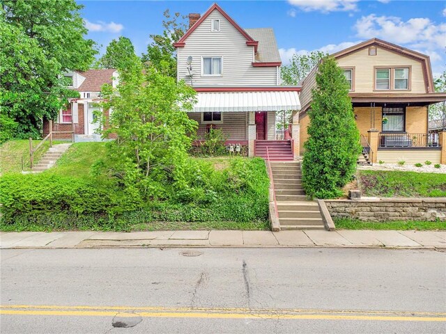 1725 Arlington Ave, South Side, PA 15210 - view of front of home with covered porch, stairway, and a chimney