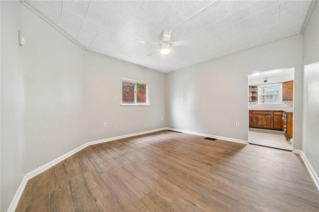 1725 Arlington Ave, South Side, PA 15210 - spare room featuring ceiling fan, wood finished floors, crown molding, and baseboards