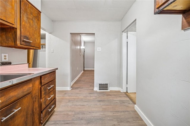 1725 Arlington Ave, South Side, PA 15210 - kitchen featuring light wood-style flooring, light countertops, a sink, baseboards, and brown cabinetry
