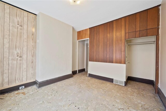 410 Orwell Way, Bloomfield, PA 15224 - unfurnished bedroom featuring wood walls and baseboards