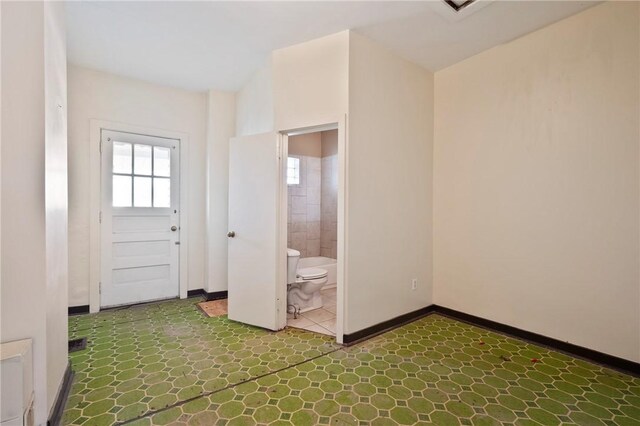 410 Orwell Way, Bloomfield, PA 15224 - unfurnished bedroom featuring baseboards and connected bathroom