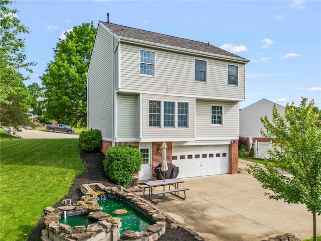 8 Trotwood Cir, North Strabane, PA 15317 - colonial home with concrete driveway, an attached garage, a front yard, brick siding, and an in-ground hot tub