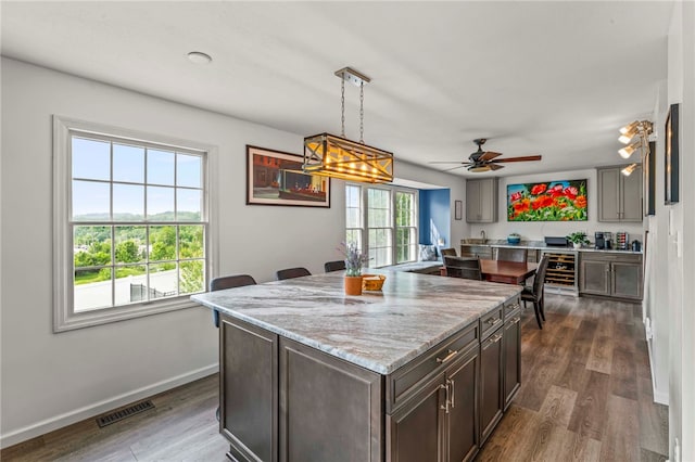 8 Trotwood Cir, North Strabane, PA 15317 - kitchen with wine cooler, ceiling fan, light stone counters, dark wood finished floors, and pendant lighting