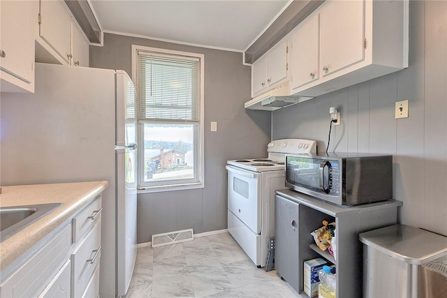 kitchen featuring white appliances, light marble finish floors, under cabinet range hood, baseboards, and white cabinets