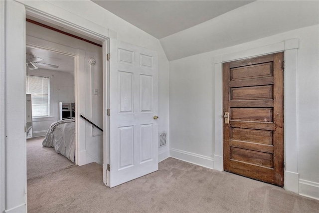 entrance foyer featuring light carpet, lofted ceiling, baseboards, and a ceiling fan