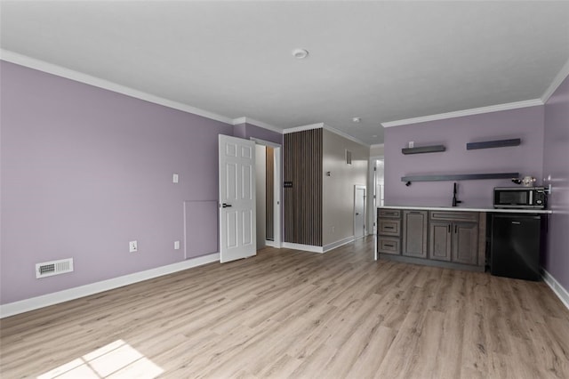 218 St Andrews, North Strabane, PA 15317 - kitchen with stainless steel microwave, baseboards, light wood finished floors, a sink, and ornamental molding