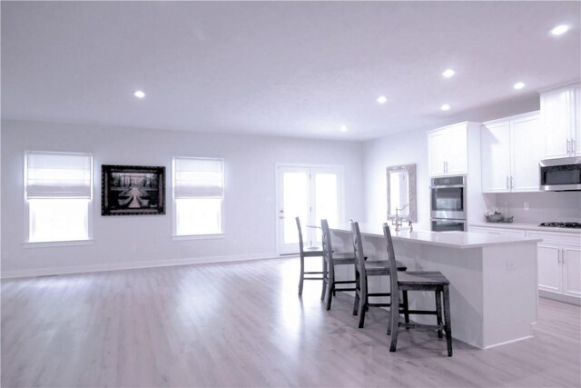 218 St Andrews, North Strabane, PA 15317 - kitchen with stainless steel appliances, a center island with sink, white cabinets, recessed lighting, and light wood-type flooring