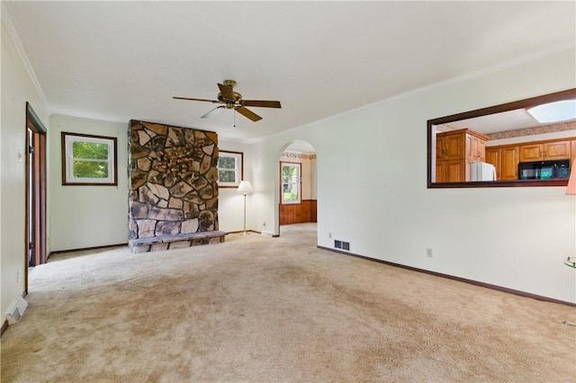 2703 Conway Wallrose Rd, Economy, PA 15005 - unfurnished living room featuring crown molding, a ceiling fan, carpet flooring, arched walkways, and baseboards