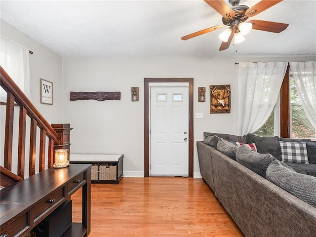 258 Wayne St, Baden, PA 15005 - living room featuring light wood finished floors, ceiling fan, stairway, and baseboards