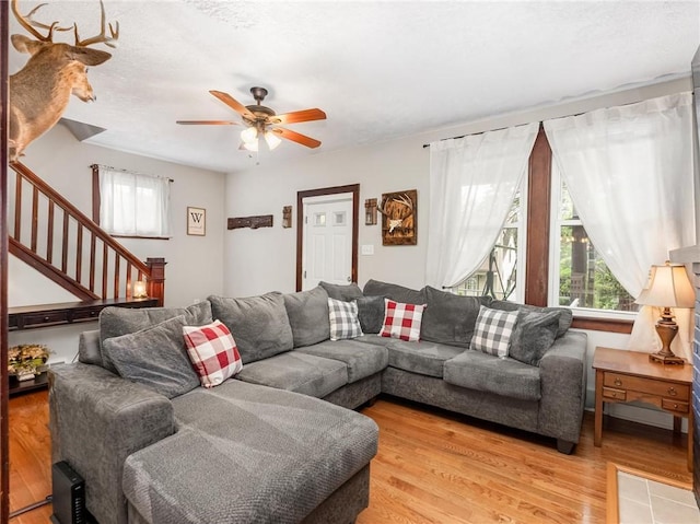 258 Wayne St, Baden, PA 15005 - living area with plenty of natural light, stairs, a ceiling fan, and light wood-style floors