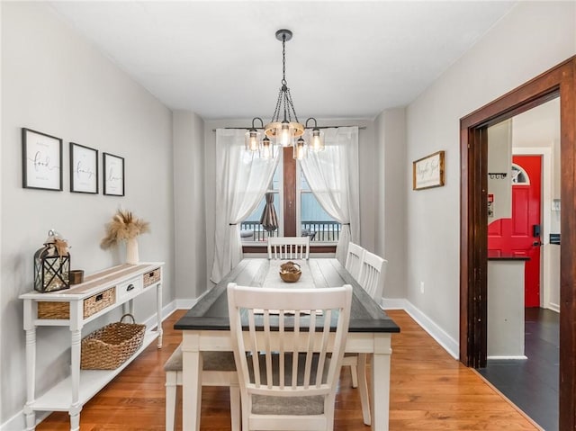 258 Wayne St, Baden, PA 15005 - dining space featuring a chandelier, wood finished floors, and baseboards