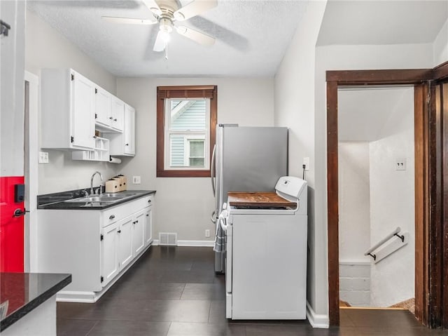 258 Wayne St, Baden, PA 15005 - kitchen featuring a sink, washer / clothes dryer, white cabinetry, a ceiling fan, and dark countertops