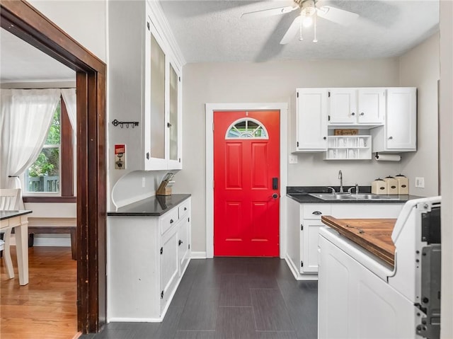 258 Wayne St, Baden, PA 15005 - kitchen with a sink, white cabinets, ceiling fan, dark wood-style floors, and a textured ceiling