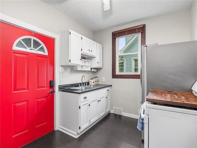 258 Wayne St, Baden, PA 15005 - kitchen featuring a sink, white range oven, baseboards, and white cabinets