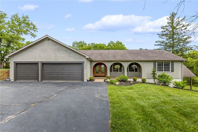 449 Bateman Rd, North Fayette, PA 15071 - single story home featuring stucco siding, asphalt driveway, an attached garage, a front lawn, and french doors