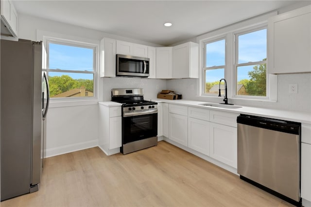 3510 Middletown Rd, Crafton Heights, PA 15204 - kitchen featuring stainless steel appliances, a sink, light wood finished floors, white cabinets, and recessed lighting