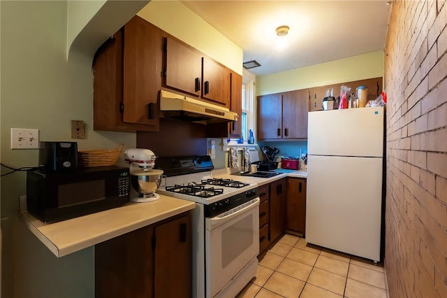 422 Hays Ave, Mount Oliver, PA 15210 - kitchen with white appliances, under cabinet range hood, light countertops, and light tile patterned flooring