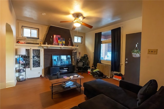 422 Hays Ave, Mount Oliver, PA 15210 - living area with radiator, ceiling fan, wood finished floors, and arched walkways