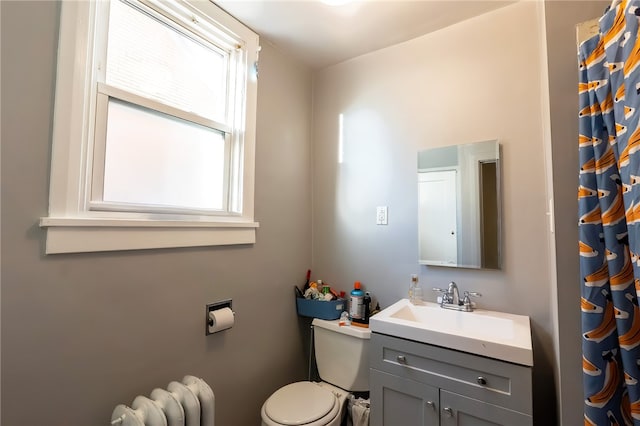 422 Hays Ave, Mount Oliver, PA 15210 - bathroom with radiator, toilet, vanity, and a shower with shower curtain
