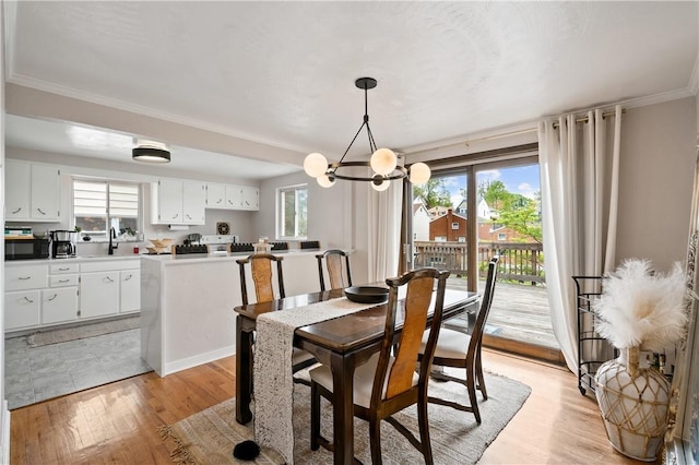 2351 Saranac Ave, Beechview, PA 15216 - dining room featuring ornamental molding, a chandelier, and light wood-type flooring
