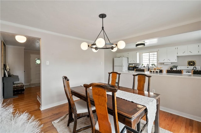 2351 Saranac Ave, Beechview, PA 15216 - dining room with crown molding, wood finished floors, baseboards, and a chandelier