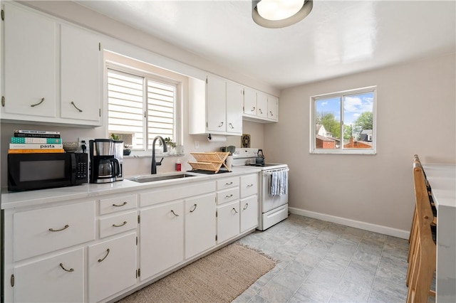 2351 Saranac Ave, Beechview, PA 15216 - kitchen featuring white range with electric stovetop, black microwave, a sink, baseboards, and white cabinetry