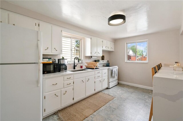 2351 Saranac Ave, Beechview, PA 15216 - kitchen with white appliances, a sink, baseboards, light countertops, and white cabinets