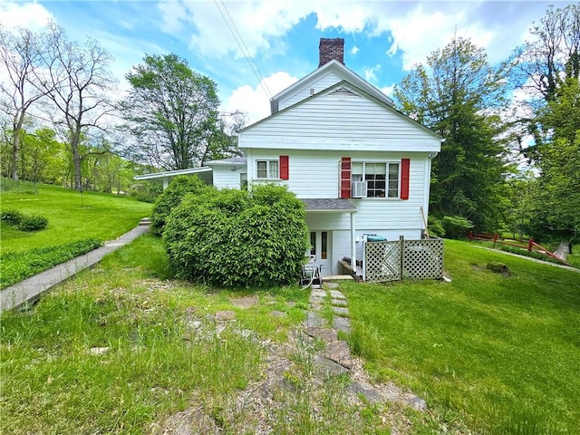 235 Mcclay Rd, Canton Twp, PA 15301 - rear view of house featuring a chimney, a yard, and cooling unit