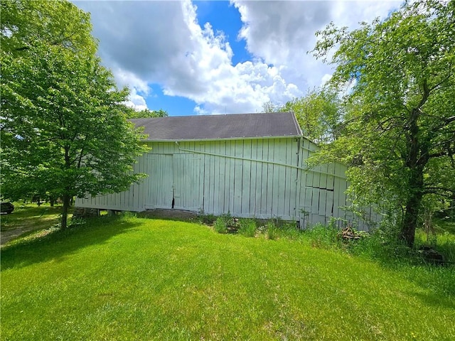 235 Mcclay Rd, Canton Twp, PA 15301 - view of side of property featuring an outbuilding, a lawn, and board and batten siding