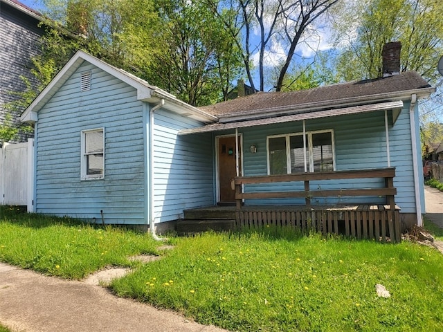 view of front of property featuring a porch and a chimney