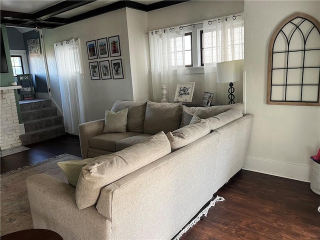 living room featuring dark wood-type flooring, baseboards, beamed ceiling, and coffered ceiling