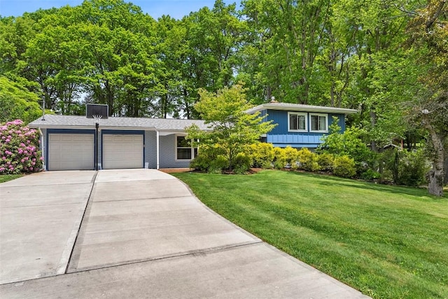 109 Meadowvue Dr, Marshall, PA 15090 - split level home with an attached garage, driveway, a front yard, and brick siding