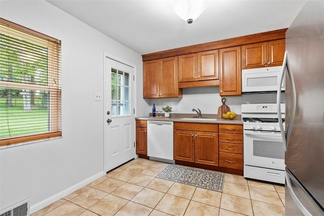 109 Meadowvue Dr, Marshall, PA 15090 - kitchen with white appliances, brown cabinetry, a sink, and light tile patterned floors