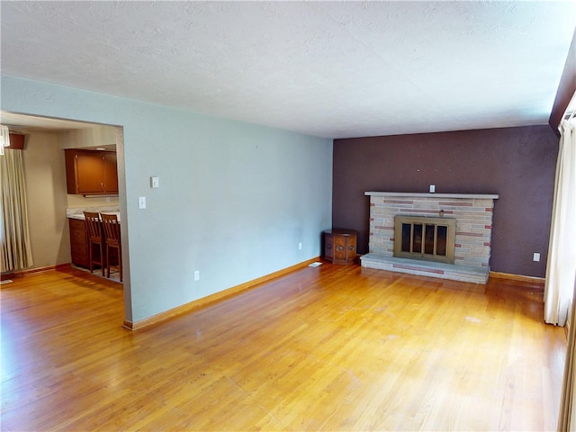 306 Cherokee Dr, Center Twp But, PA 16001 - unfurnished living room featuring light wood-style floors, baseboards, and a fireplace
