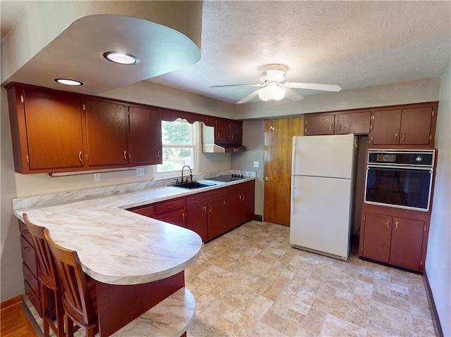 306 Cherokee Dr, Center Twp But, PA 16001 - kitchen featuring black appliances, light countertops, ceiling fan, a sink, and a peninsula