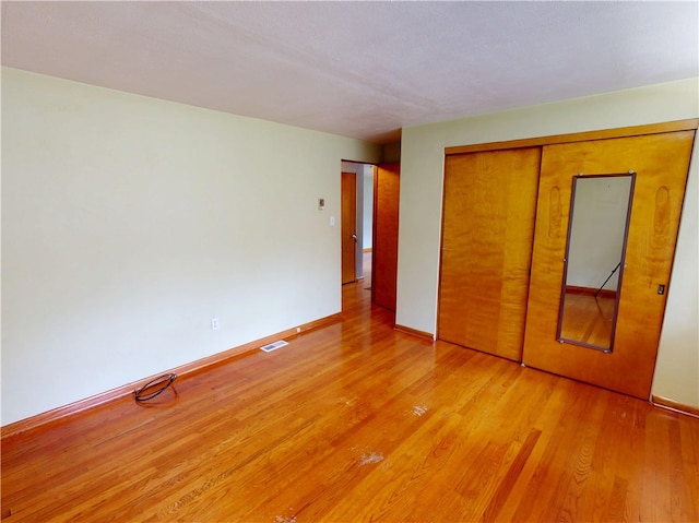 306 Cherokee Dr, Center Twp But, PA 16001 - unfurnished bedroom featuring light wood-type flooring, baseboards, and a closet