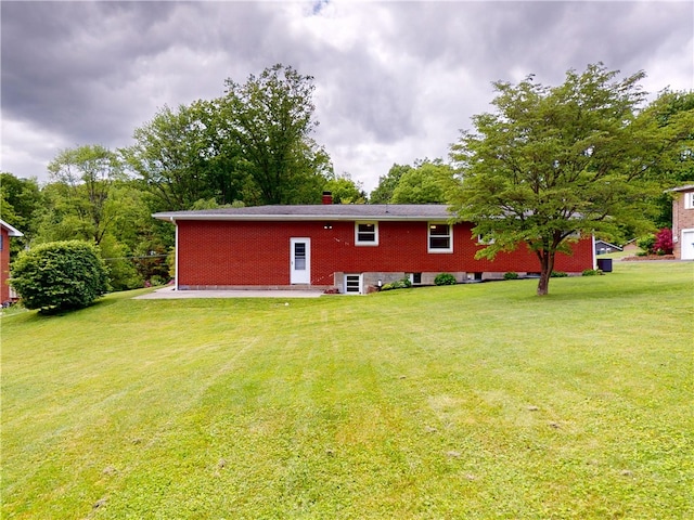 306 Cherokee Dr, Center Twp But, PA 16001 - rear view of property with a yard and brick siding