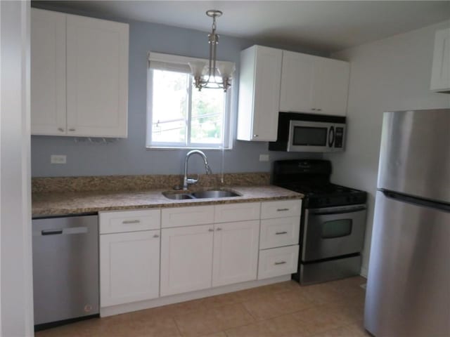 985 Mcneilly Rd, Mt Lebanon, PA 15226 - kitchen with appliances with stainless steel finishes, a sink, white cabinetry, and hanging light fixtures