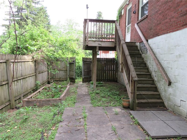 985 Mcneilly Rd, Mt Lebanon, PA 15226 - fenced backyard featuring stairs, a vegetable garden, and a wooden deck