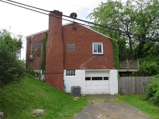 985 Mcneilly Rd, Mt Lebanon, PA 15226 - view of side of home featuring driveway, a chimney, an attached garage, and brick siding