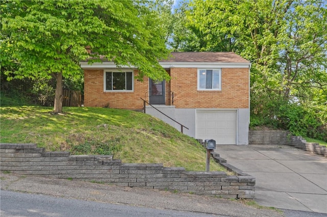 119 Hillcrest Dr, Ross Twp, PA 15237 - view of front facade featuring concrete driveway, brick siding, a garage, and a front lawn