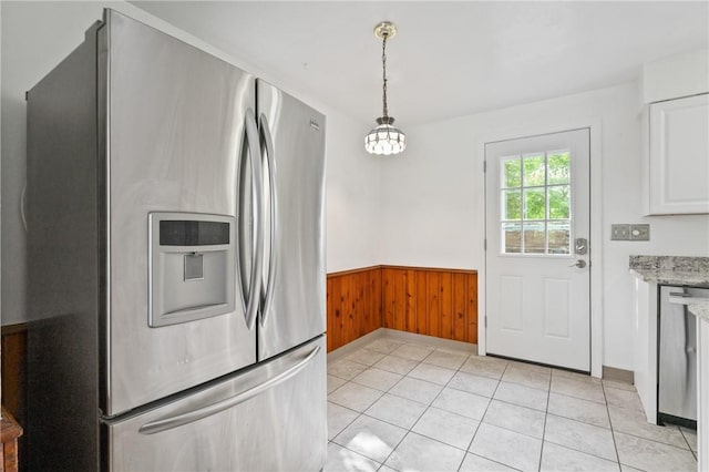 119 Hillcrest Dr, Ross Twp, PA 15237 - kitchen featuring stainless steel fridge with ice dispenser, wainscoting, wood walls, white cabinets, and light tile patterned floors