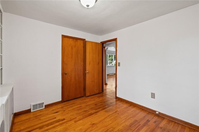 119 Hillcrest Dr, Ross Twp, PA 15237 - unfurnished bedroom with baseboards, light wood-style floors, and a closet