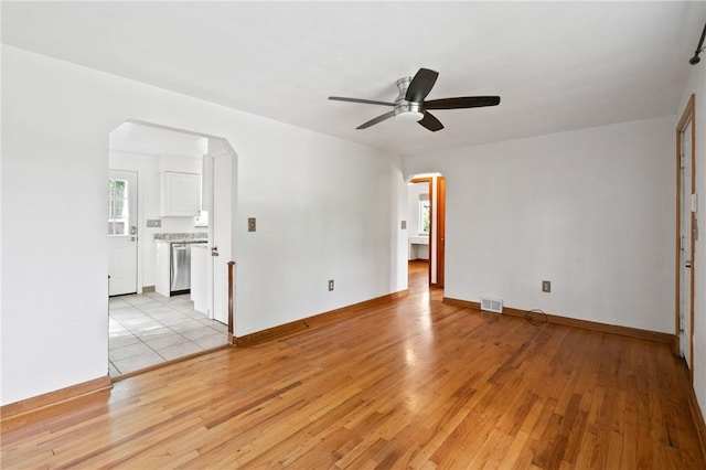 119 Hillcrest Dr, Ross Twp, PA 15237 - unfurnished room with arched walkways, ceiling fan, light wood-type flooring, and baseboards